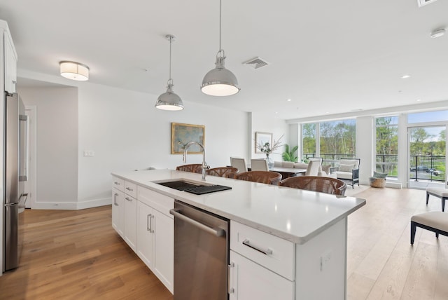 267 US Route 1 Unit 206, Falmouth, ME 04105 - kitchen featuring stainless steel appliances, a sink, light wood finished floors, open floor plan, and recessed lighting