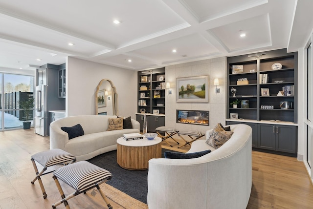 267 US Route 1 Unit 206, Falmouth, ME 04105 - living area featuring a fireplace, light wood finished floors, coffered ceiling, built in shelves, and beamed ceiling