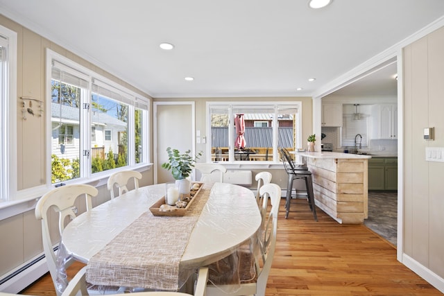 10 Lake Ave, Old Orchard Beach, ME 04064 - dining room featuring plenty of natural light, ornamental molding, light wood-type flooring, a baseboard radiator, and recessed lighting