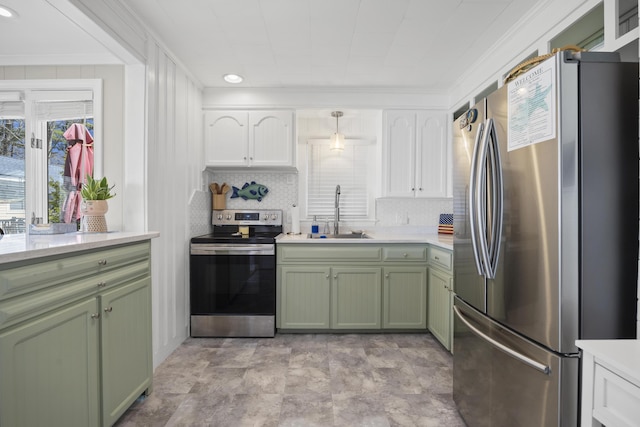 10 Lake Ave, Old Orchard Beach, ME 04064 - kitchen featuring green cabinets, appliances with stainless steel finishes, a sink, light countertops, and tasteful backsplash