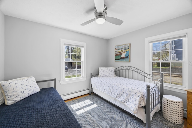 10 Lake Ave, Old Orchard Beach, ME 04064 - bedroom with a baseboard heating unit, wood finished floors, and a ceiling fan