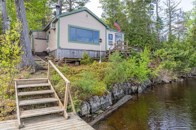 18 Breezy Knoll Dr, Princeton, ME 04668 - rear view of house featuring stairs, a wall mounted AC, and a deck with water view