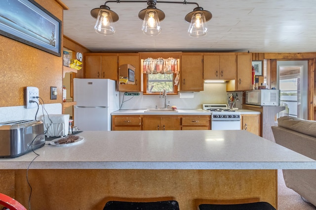 18 Breezy Knoll Dr, Princeton, ME 04668 - kitchen with white appliances, a sink, light countertops, and brown cabinets