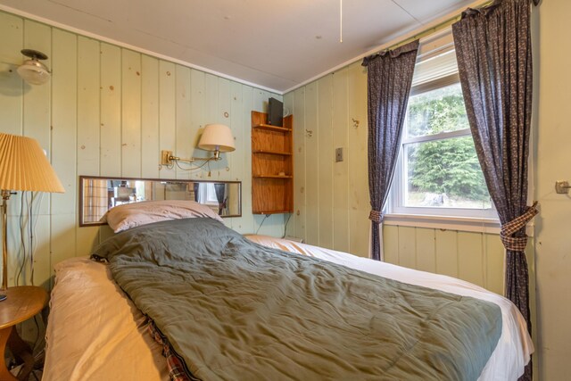 18 Breezy Knoll Dr, Princeton, ME 04668 - bedroom with multiple windows, crown molding, and wooden walls