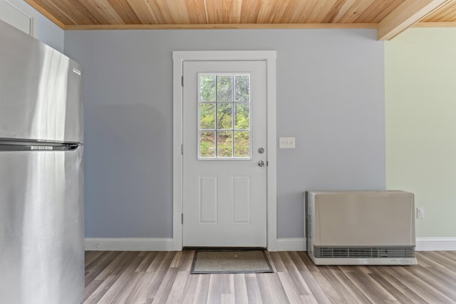 301 Pine Springs Rd, Shapleigh, ME 04076 - doorway featuring wood ceiling, wood finished floors, baseboards, and heating unit