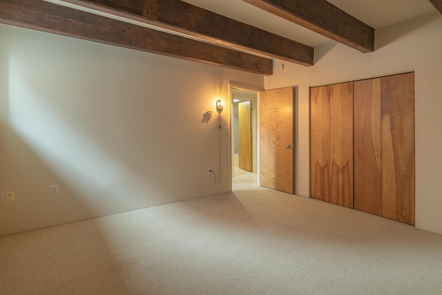 20 W St Unit 3, Portland, ME 04102 - unfurnished bedroom featuring carpet, beam ceiling, and a closet