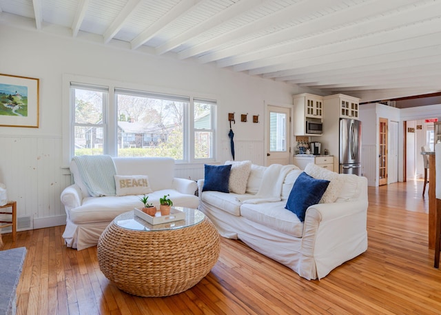 11 Saccarappa Ln, Scarborough, ME 04074 - living room featuring beamed ceiling, light wood-style floors, and wainscoting