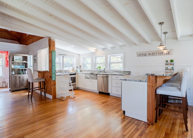 11 Saccarappa Ln, Scarborough, ME 04074 - kitchen featuring stainless steel appliances, a peninsula, a kitchen bar, light wood-style flooring, and wood ceiling