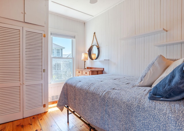 11 Saccarappa Ln, Scarborough, ME 04074 - bedroom with hardwood / wood-style floors, a closet, a ceiling fan, and wooden walls