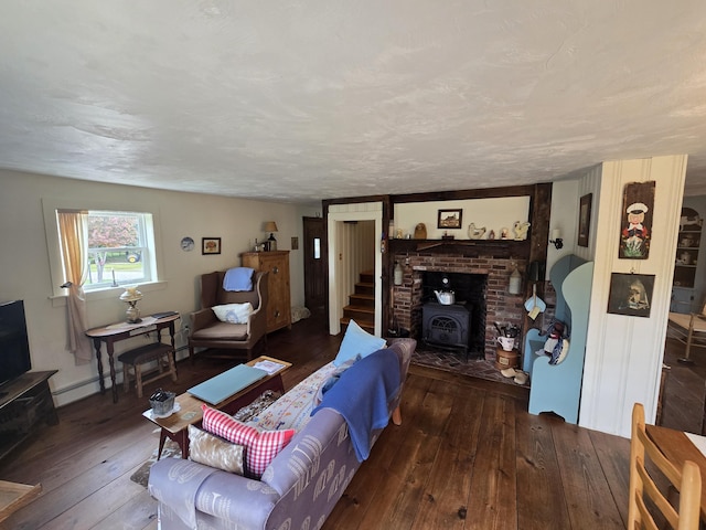 13 Bishop Farm Rd, Brownfield, ME 04010 - living area featuring hardwood / wood-style floors, a wood stove, and a baseboard heating unit