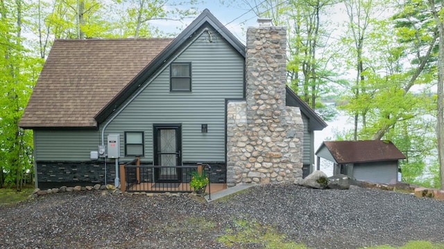 7 Scenic View Dr, Naples, ME 04055 - view of front of house featuring roof with shingles and a chimney