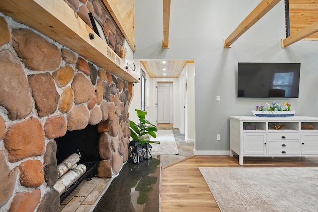 7 Scenic View Dr, Naples, ME 04055 - living room with wood finished floors, baseboards, and a stone fireplace