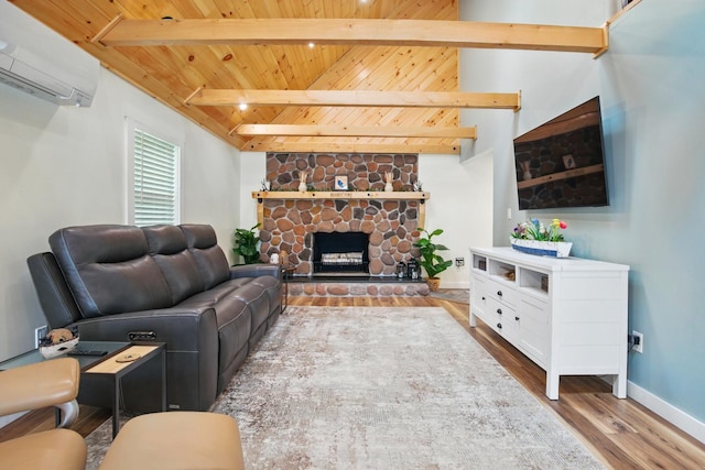 7 Scenic View Dr, Naples, ME 04055 - living room with wooden ceiling with exposed beams, a wall mounted AC, wood finished floors, baseboards, and a fireplace