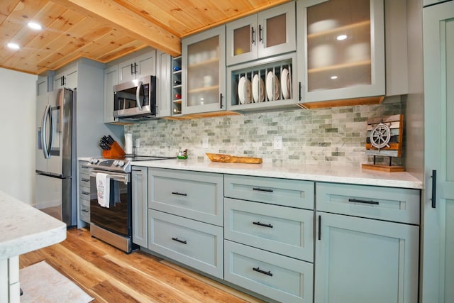 7 Scenic View Dr, Naples, ME 04055 - kitchen with appliances with stainless steel finishes, wooden ceiling with exposed beams, light wood-type flooring, tasteful backsplash, and glass insert cabinets