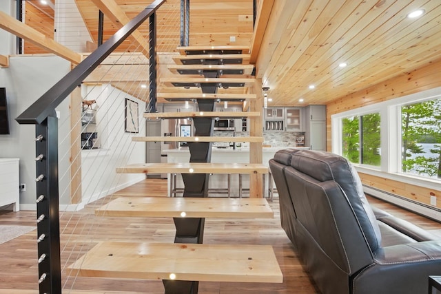 7 Scenic View Dr, Naples, ME 04055 - living room featuring baseboard heating, wood finished floors, recessed lighting, wooden ceiling, and stairway