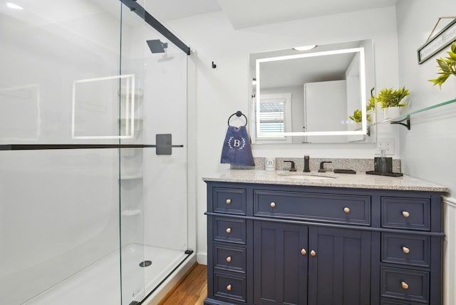 7 Scenic View Dr, Naples, ME 04055 - full bathroom featuring a shower stall, wood finished floors, and vanity