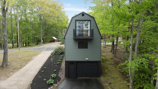 7 Scenic View Dr, Naples, ME 04055 - view of property exterior with a gambrel roof, a balcony, an attached garage, and asphalt driveway