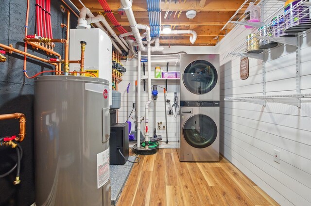 7 Scenic View Dr, Naples, ME 04055 - washroom featuring electric water heater, stacked washer / drying machine, and wood finished floors