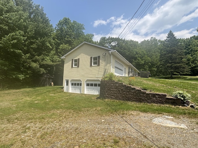 270 Mccrillis Corner Rd, Wilton, ME 04294 - view of property exterior featuring driveway, a garage, and a lawn