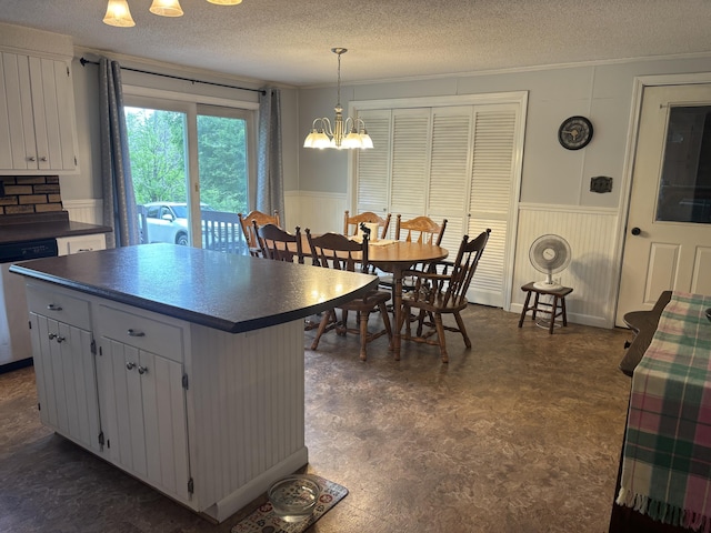 270 Mccrillis Corner Rd, Wilton, ME 04294 - kitchen with wainscoting, dishwasher, dark countertops, a textured ceiling, and a chandelier