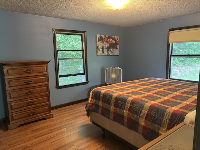 270 Mccrillis Corner Rd, Wilton, ME 04294 - bedroom featuring light wood-type flooring and a textured ceiling