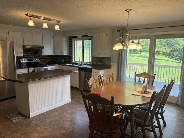 270 Mccrillis Corner Rd, Wilton, ME 04294 - dining room featuring a textured ceiling and a chandelier