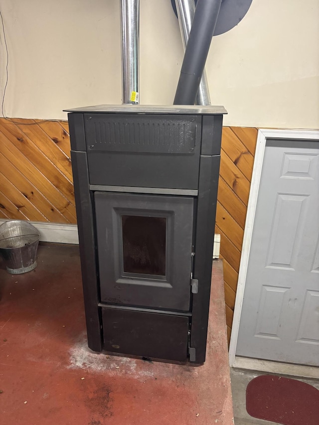 270 Mccrillis Corner Rd, Wilton, ME 04294 - detailed view of concrete floors, wood walls, and a wood stove