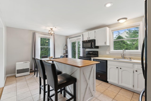 7 Apple Ledge Dr Unit 7A, Portland, ME 04103 - kitchen with black appliances, a sink, light tile patterned flooring, white cabinetry, and healthy amount of natural light