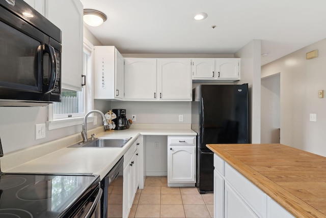 7 Apple Ledge Dr Unit 7A, Portland, ME 04103 - kitchen with black appliances, a sink, white cabinets, light tile patterned floors, and recessed lighting