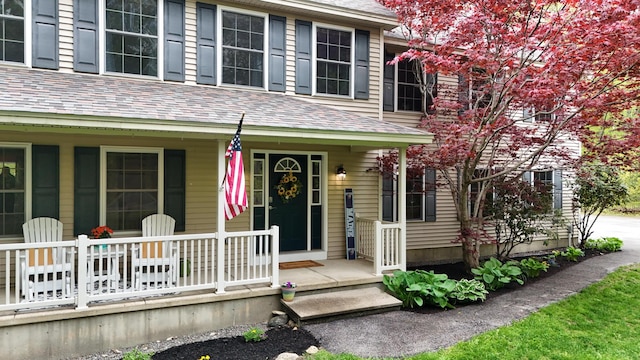 30 Maxfield Dr, Orono, ME 04473 - property entrance with covered porch and a shingled roof