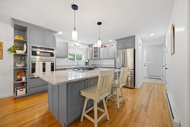 30 Maxfield Dr, Orono, ME 04473 - kitchen featuring stainless steel appliances, gray cabinets, a baseboard heating unit, a center island, and light wood-type flooring