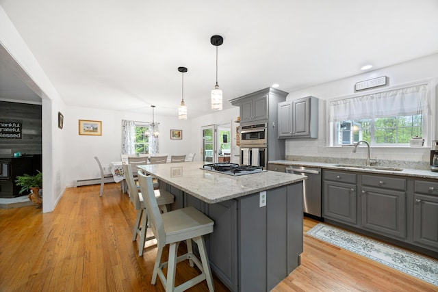 30 Maxfield Dr, Orono, ME 04473 - kitchen with gray cabinets, stainless steel appliances, a sink, and a baseboard heating unit