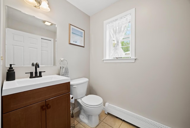 30 Maxfield Dr, Orono, ME 04473 - half bath with a baseboard heating unit, toilet, tile patterned floors, baseboards, and vanity