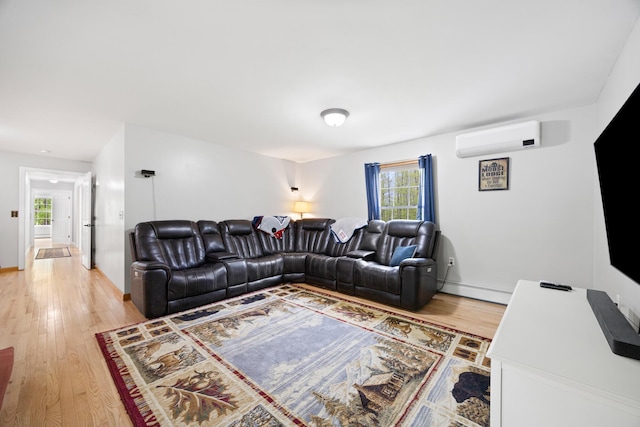 30 Maxfield Dr, Orono, ME 04473 - living room with an AC wall unit, light wood finished floors, and healthy amount of natural light