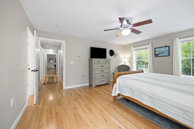30 Maxfield Dr, Orono, ME 04473 - bedroom with light wood-style flooring, multiple windows, baseboards, and a ceiling fan