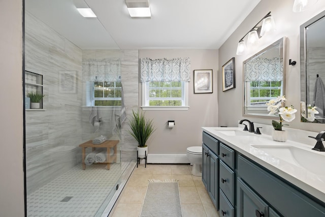 30 Maxfield Dr, Orono, ME 04473 - full bathroom with a tile shower, tile patterned floors, toilet, double vanity, and baseboards