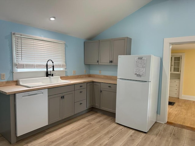 70 Pearl St, Bangor, ME 04401 - kitchen with white appliances, gray cabinetry, a sink, lofted ceiling, and light countertops