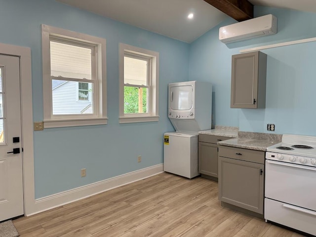 70 Pearl St, Bangor, ME 04401 - kitchen featuring white electric stove, estacked washer and dryer, gray cabinetry, a wall mounted AC, and recessed lighting