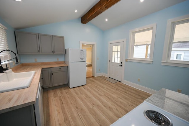 70 Pearl St, Bangor, ME 04401 - kitchen with freestanding refrigerator, a sink, gray cabinets, butcher block counters, and light wood-style flooring