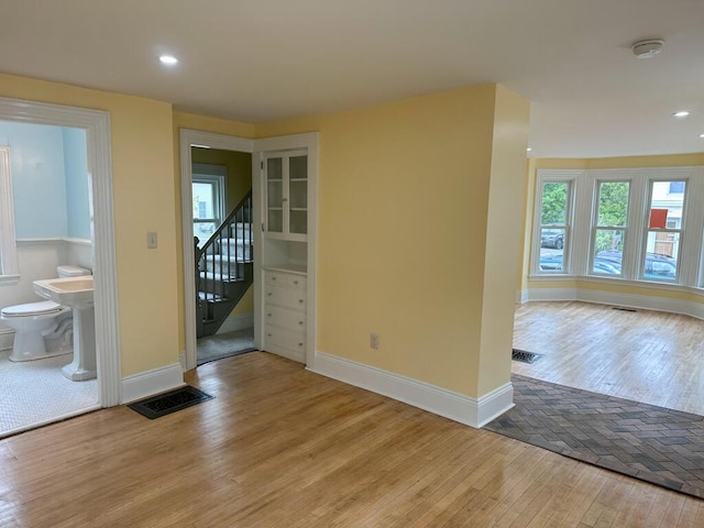 70 Pearl St, Bangor, ME 04401 - empty room featuring wood finished floors, baseboards, stairs, recessed lighting, and a smoke detector