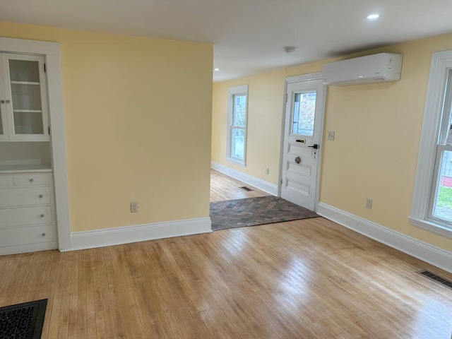 70 Pearl St, Bangor, ME 04401 - entrance foyer featuring an AC wall unit, light wood-style floors, baseboards, and recessed lighting