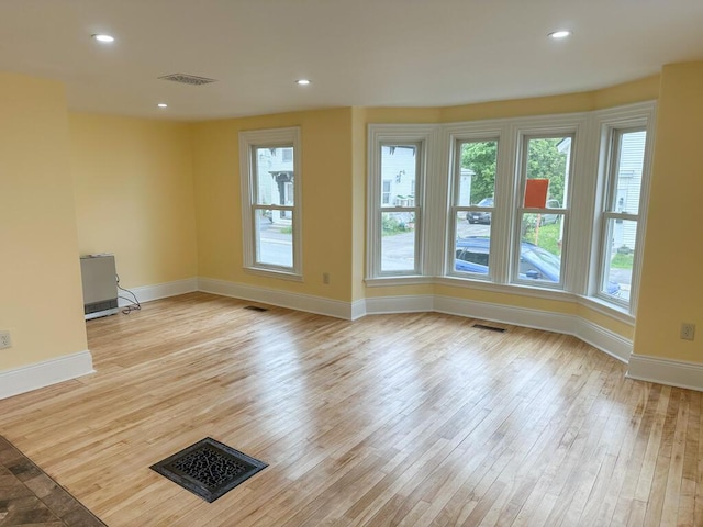 70 Pearl St, Bangor, ME 04401 - unfurnished living room featuring hardwood / wood-style floors, baseboards, healthy amount of natural light, and recessed lighting