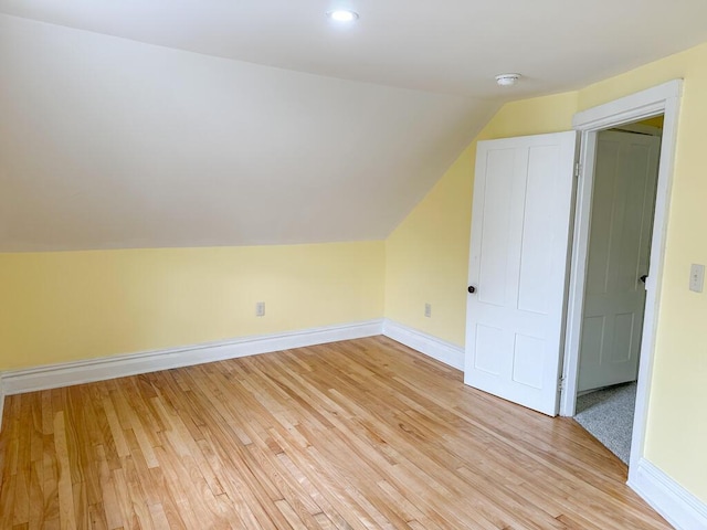 70 Pearl St, Bangor, ME 04401 - additional living space with vaulted ceiling, light wood finished floors, and baseboards