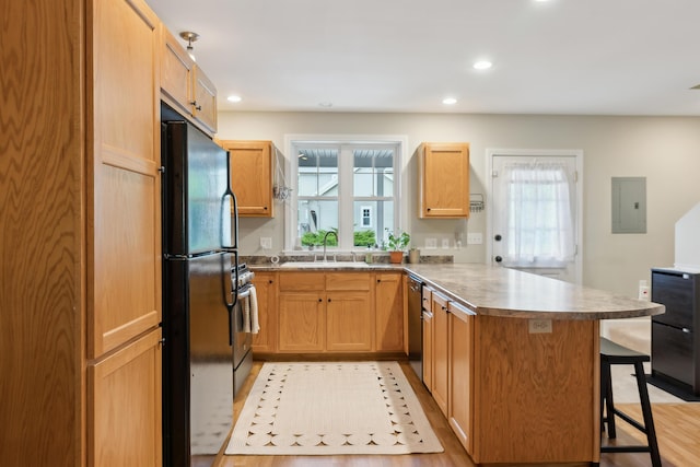 32 Edgefield Ln Unit 5, Brunswick, ME 04011 - kitchen featuring a peninsula, dishwashing machine, freestanding refrigerator, a sink, and electric panel