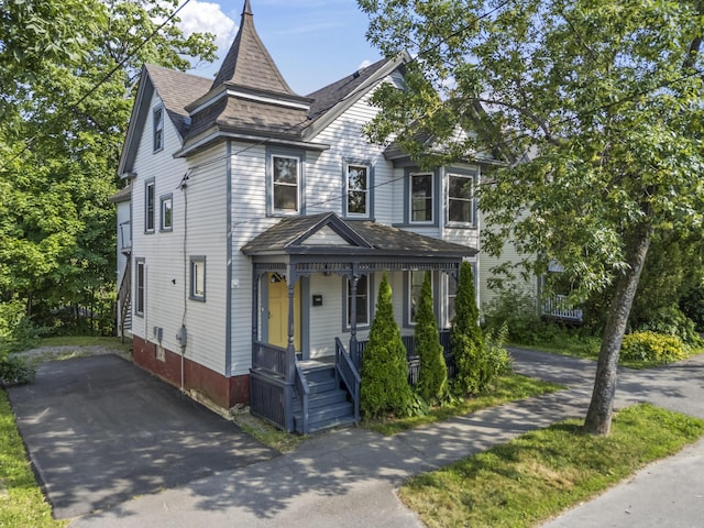 130 W Broadway, Bangor, ME 04401 - victorian home featuring covered porch, a shingled roof, and driveway