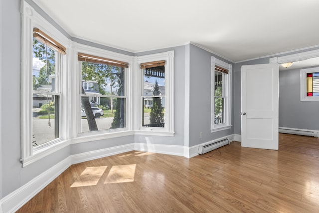 130 W Broadway, Bangor, ME 04401 - unfurnished room featuring a baseboard radiator, wood finished floors, healthy amount of natural light, and ornamental molding