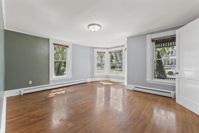 130 W Broadway, Bangor, ME 04401 - spare room featuring a baseboard heating unit, healthy amount of natural light, wood finished floors, and ornamental molding