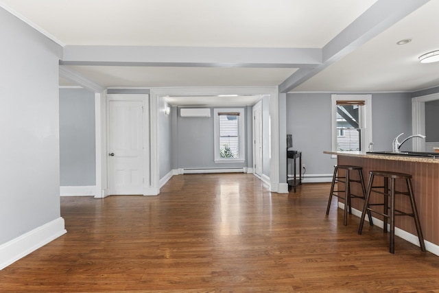 130 W Broadway, Bangor, ME 04401 - interior space featuring a wall mounted AC, a baseboard heating unit, and dark wood finished floors