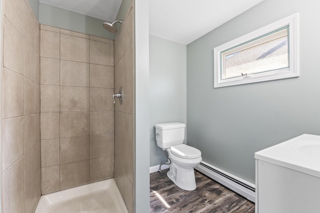 130 W Broadway, Bangor, ME 04401 - full bathroom with a baseboard heating unit, a tile shower, vanity, and wood finished floors