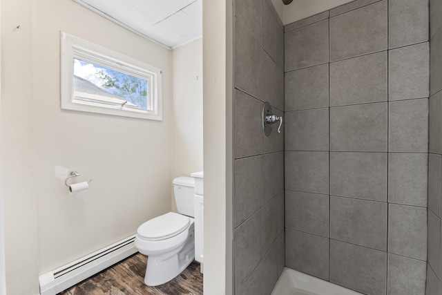 130 W Broadway, Bangor, ME 04401 - bathroom with a baseboard radiator, a tile shower, and wood finished floors